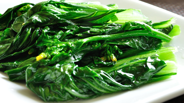 Cooked greens on white plate
