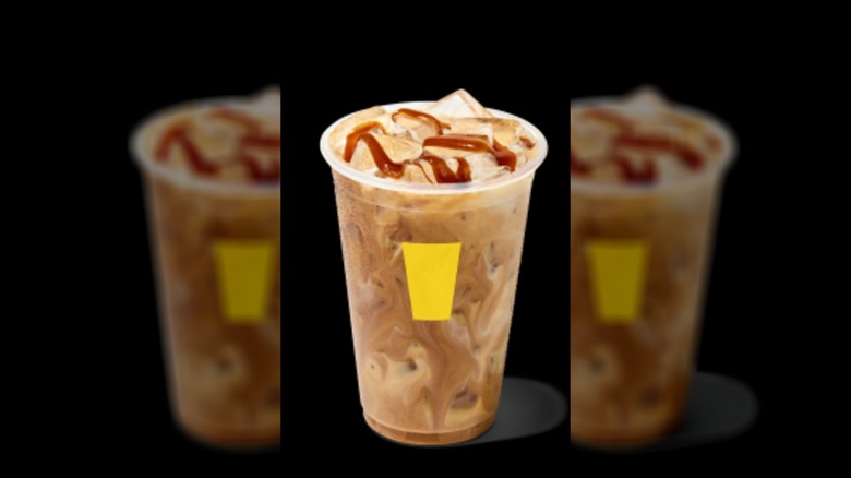 CosMc's Iced French Toast Galaxy Latte against a black background