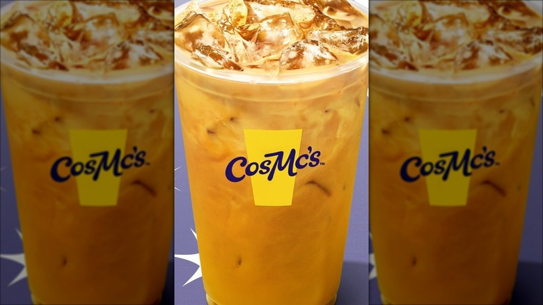 CosMc's iced turmeric spiced latte on a sparkly purple background