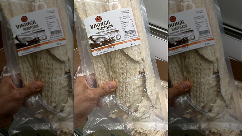 Mirrored image of hand holding packet of Hardfiskur