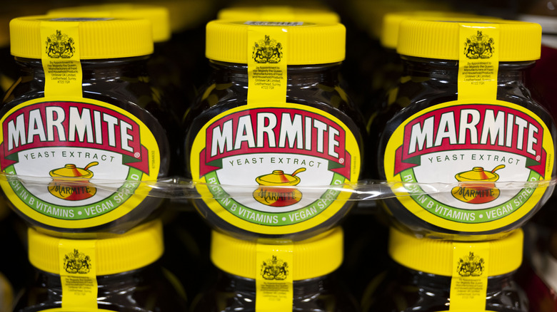 Jars of Marmite lined up on a supermarket shelf