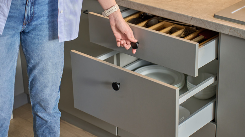 person opening cabinet drawers