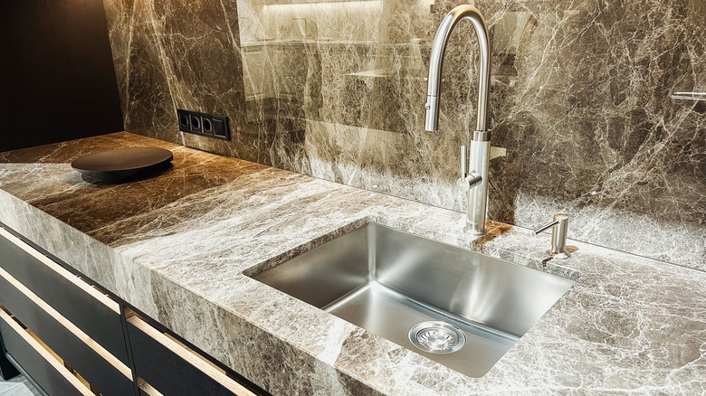 kitchen with fancy stone countertop and backsplash