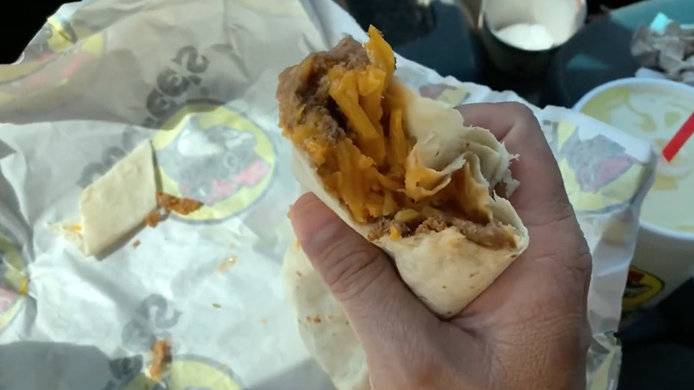 Customer holding Buc-ee's Beef, Bean, and Cheese Burrito