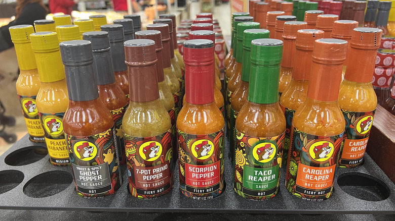 Different flavors of Buc-ee's hot sauces on shelf.