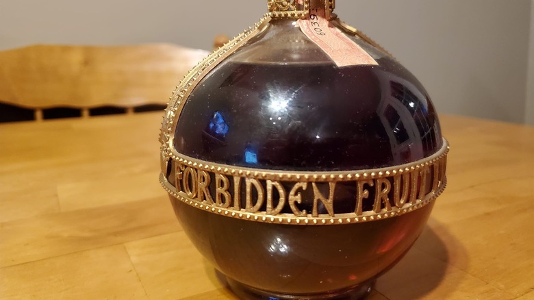 close up of Forbidden Fruit bottle on wooden table