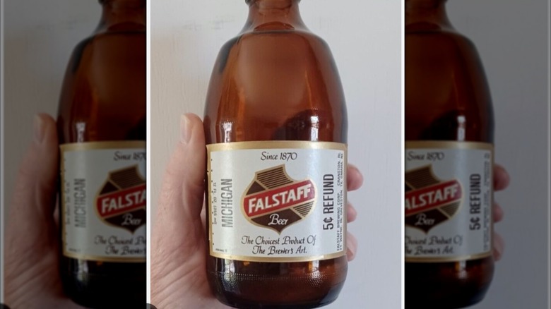 hand holding falstaff bottle mirrored image