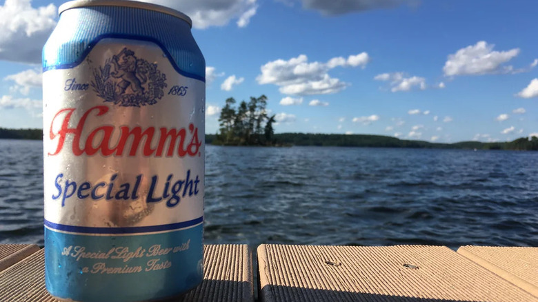 Hamm's Special Light can against lake background