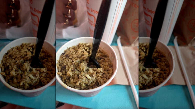 Popeyes Cajun rice in small paper bowl with fork