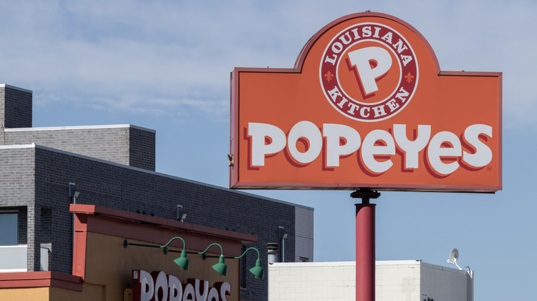 Popeyes sign in front of restaurant