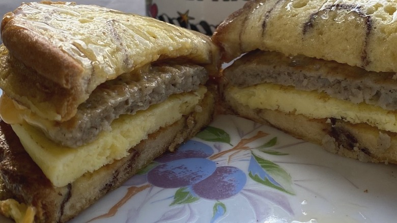 Layered sausage, egg, and cheese breakfast sandwich in halves