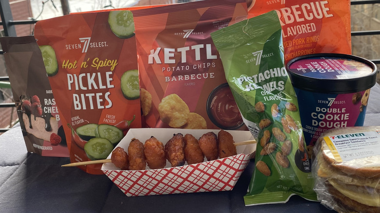 Chicken bites, breakfast sandwich, chips, and other snacks on gray tablecloth