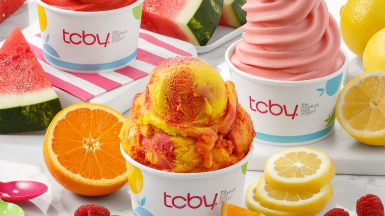 Cups of colorful frozen yogurt with fresh fruits