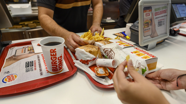 Employee handing customer food at a Burger King