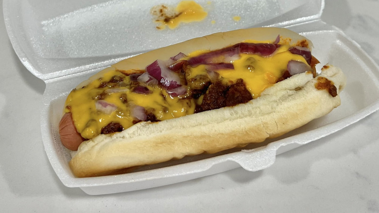 Rally's Chili Dog with Cheese Sauce in to-go box.