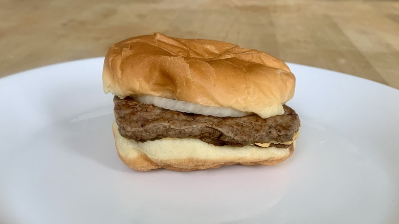 Wendy's double cheeseburger on white plate with wooden background