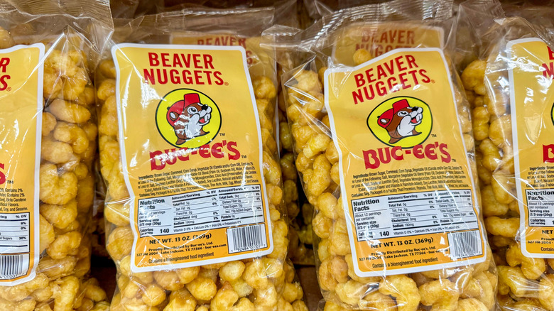 A row of transparent bags of Beaver Nuggets on a shelf.