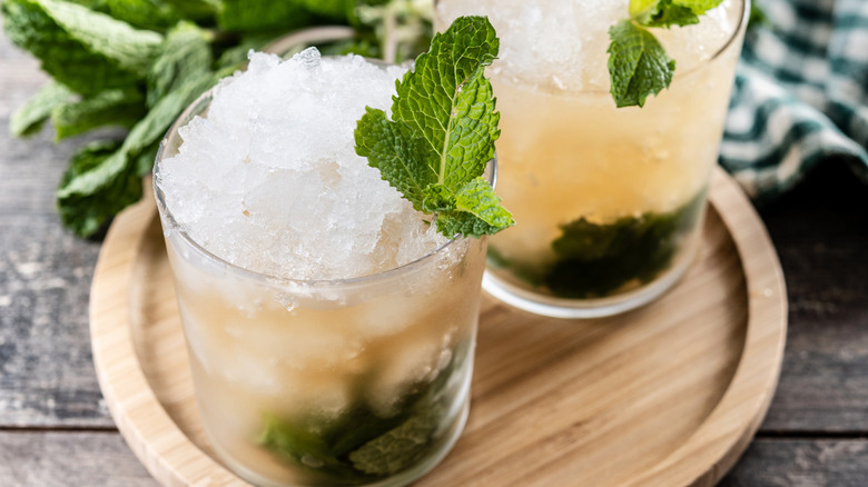 A cocktail glass with crushed ice and mint