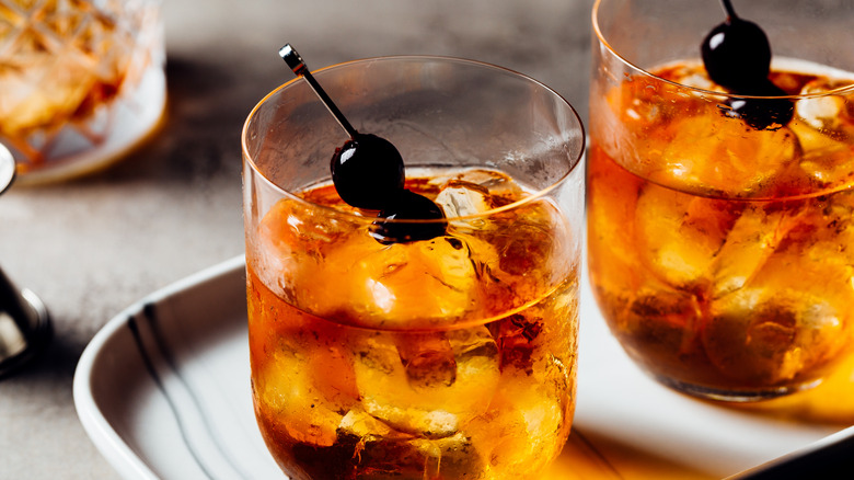 Two cocktail glasses with cherries