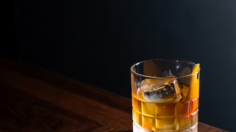A golden cocktail on a black background