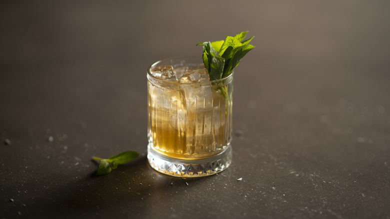 A cocktail glass with herbs