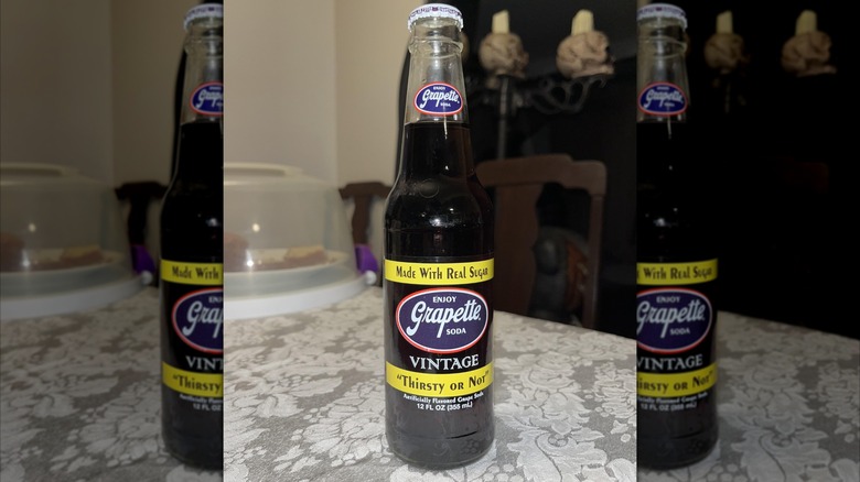 Bottle of Grapette on table in dining room, mirrored image