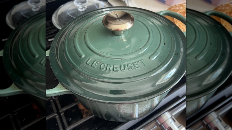 Used green Le Creuset pan on a stove top