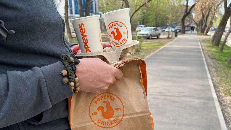 Person with a bag of food from Popeyes
