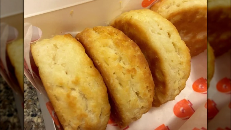 Three Popeyes biscuits in a to go container