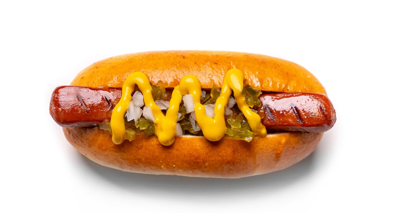 Hot dog with various toppings on white background