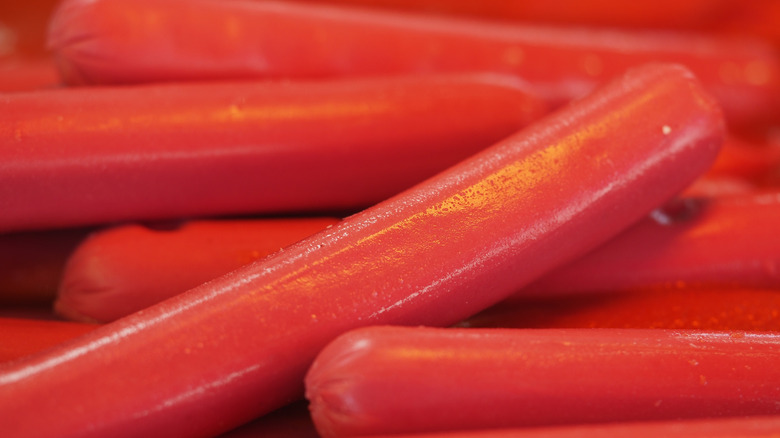 Close up of heap of red hot dogs