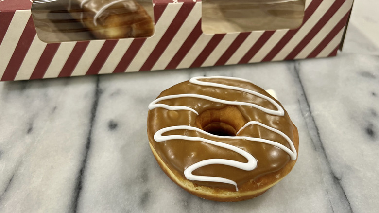 Giant Eagle maple iced donut with white drizzles.