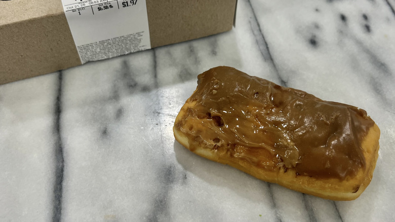 Walmart maple iced Fluff filled bar donut on a marble surface