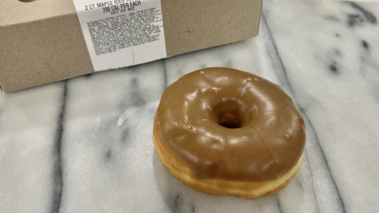 Walmart maple iced ring donut with donut box.