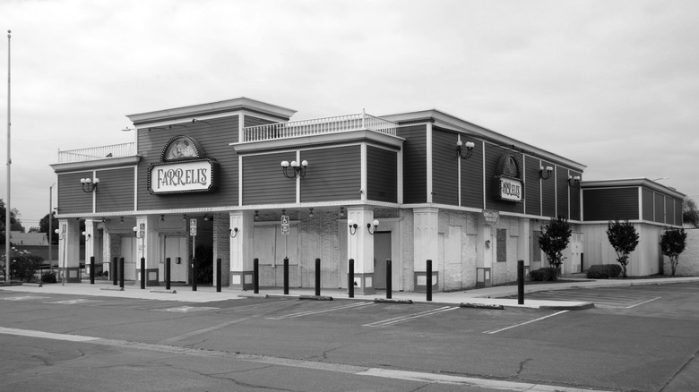 A black and white image of a Farrell's ice cream parlor in front of an empty parking lot