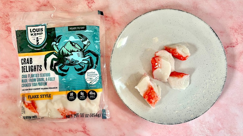 Package of Louis Kemp imitation crab next to imitation crab on white plate