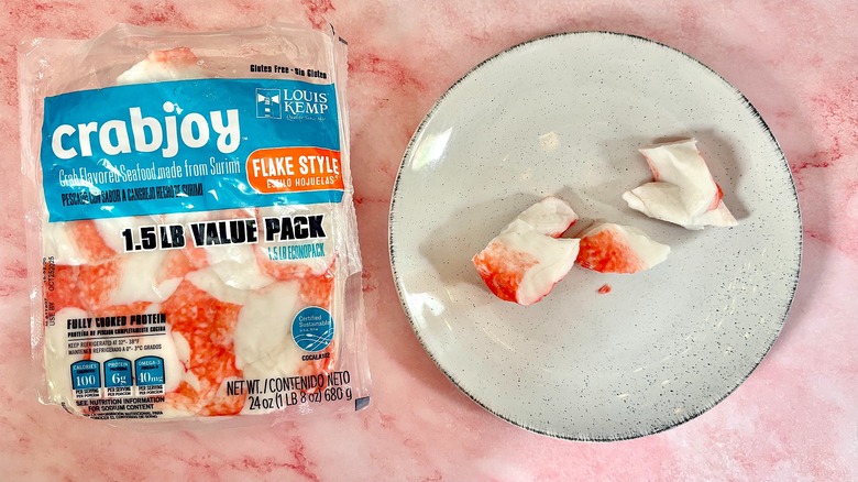 Package of Crabjoy imitation crab next to imitation crab on white plate