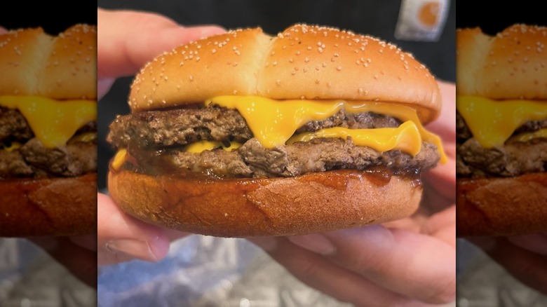 Hands holding McDonald's Roasted Soy Sauce Double Thick Beef
