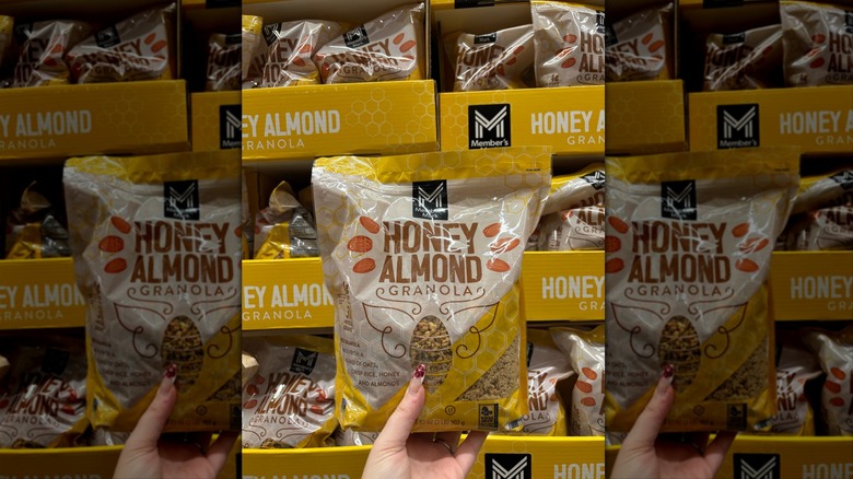 Hand holding Member's Mark granola at Sam's Club