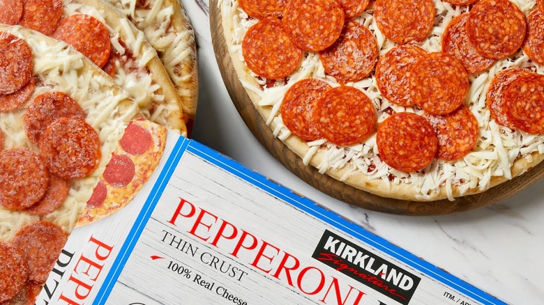 A Kirkland Signature pizza box and four pepperoni pizzas