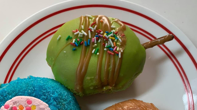 Krispy Kreme caramel apple donut on white and red plate