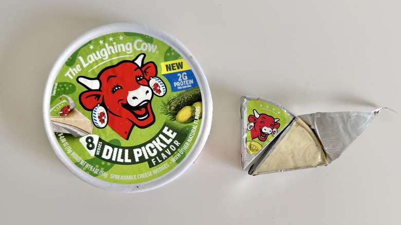 Dill Pickle cheese container and wedge on table