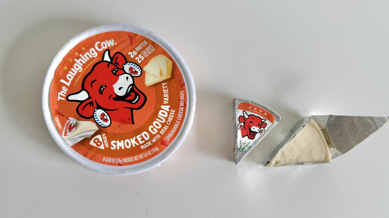 Smoked Gouda cheese round and an open cheese wedge