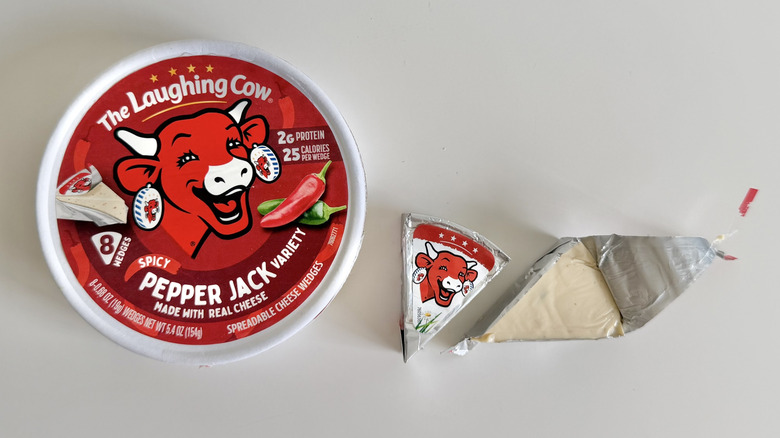 Spicy Pepper Jack cheese container and wedge on table