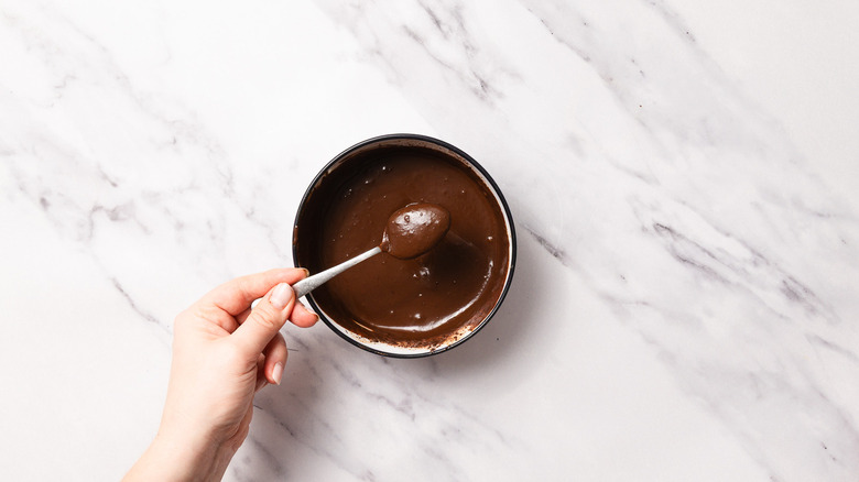 Raising spoon with chocolate ganache