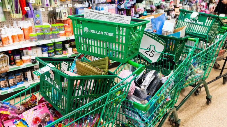 Messy Dollar Tree store with carts and baskets stacked on top of one another