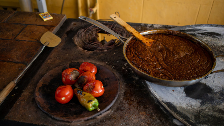 Pan of mole and peppers on stove