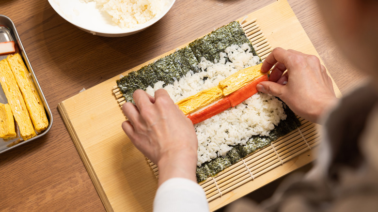Person rolling sushi