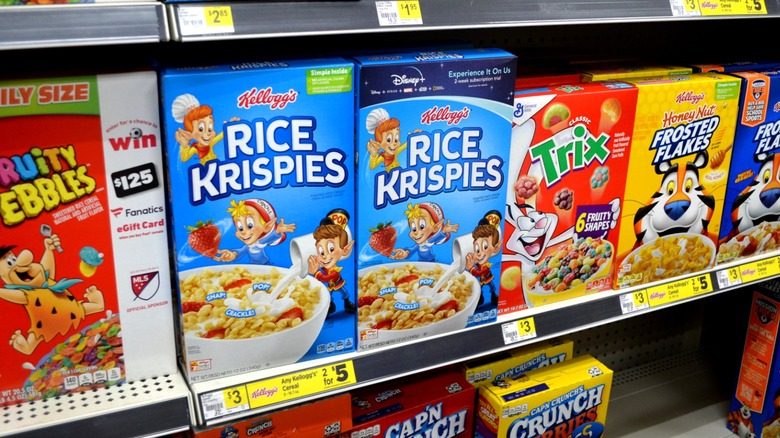 Cereal boxes on store shelf including Rice Krispies, Fruity Pebbles, Trix, and Frosted Flakes