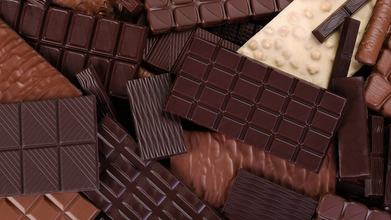 Variety of chocolate bars piled on top of each other